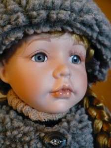 16 IN. PORCELAIN DOLLMANDY SITS ON CHAIR/WINTER HAT  