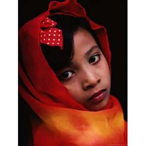 Portrait of a Muslim Girl with Her Face Framed by a Colourful Scarf 