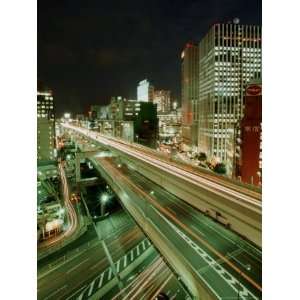 Streaks of Light Show Where Vehicles are Driving on a Highway Overpass 