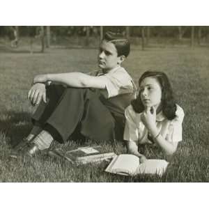 com Two Teenagers Resting in Field, Boy Sitting, Girl Lying With Book 