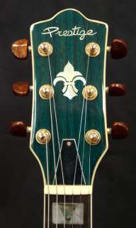 The guitar has an abalone bound, arched quilted maple body (top and 