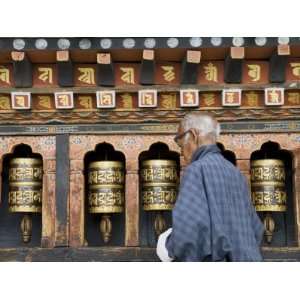  Old Bhutanese Man Turning Prayer Wheels in Buddhist Temple 