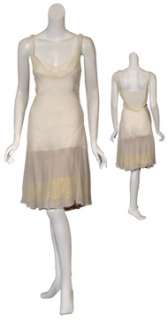 Breezy transparent dress with lace trim under skirt. Features draped 
