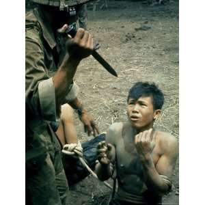 Bayonet Wielding South Vietnamese Soldier Menacing Captured Viet Cong 